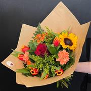 A hand tied in florists choice of autumnal 