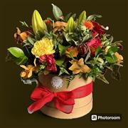 Orange, red and yellow blooms in a hat box