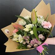 A hand tied of florist choice in pretty pastels